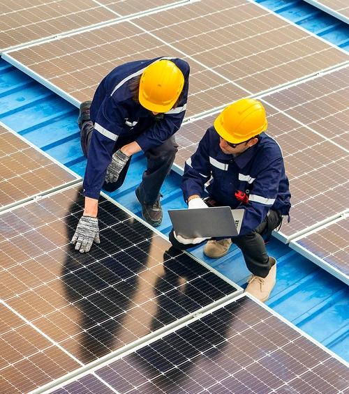 Two solar installers on warehouse roof